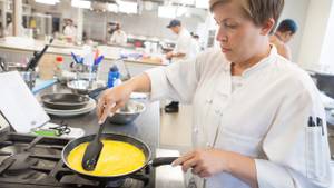 Chef cooking with a rubber spatula